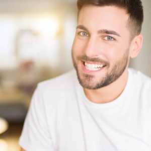 Young,Handsome,Man,Wearing,Casual,White,T-shirt,At,Home,Looking